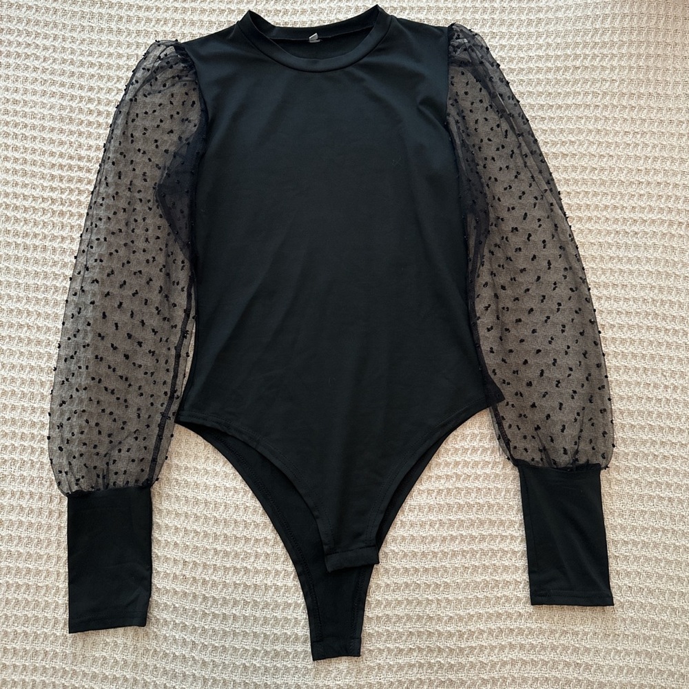 Black body suit with netted arms. Size large. Never worn. No tags.